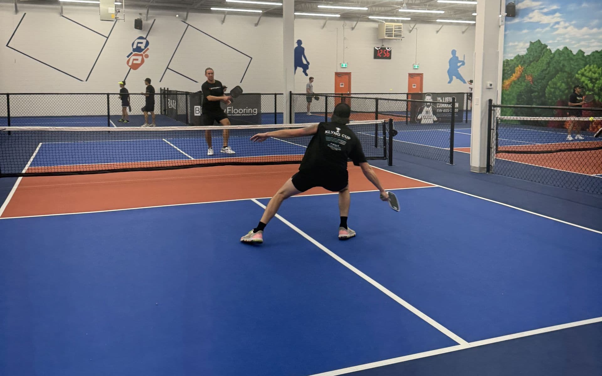 Pickleball players competing in a Klyng Cup match
